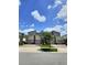 Attractive townhomes featuring modern architecture, well-maintained landscaping, and brick paved driveways at 703 Ocean Course Ave, Davenport, FL 33896