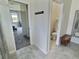 Entryway with tile flooring leading to the bedroom and the bathroom with a wooden stool at 703 Ocean Course Ave, Davenport, FL 33896