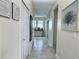 Bright hallway with neutral decor, tile flooring, doors, and stylish decorative touches at 703 Ocean Course Ave, Davenport, FL 33896