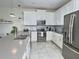 Stylish kitchen features stainless steel appliances, stone countertops and ample storage at 703 Ocean Course Ave, Davenport, FL 33896
