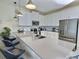 Modern kitchen featuring white cabinets, stainless steel appliances, quartz countertops, and breakfast bar seating at 703 Ocean Course Ave, Davenport, FL 33896