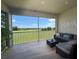 Spacious lanai with a view of a golf course and outdoor seating at 703 Ocean Course Ave, Davenport, FL 33896