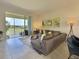 Bright living room with comfortable seating, neutral tones, and a balcony overlooking the outdoor scenery at 703 Ocean Course Ave, Davenport, FL 33896
