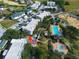 Aerial view of condo buildings, swimming pool, and fountain surrounded by manicured landscaping in a residential community at 7503 Mourning Dove Cir # 101, Reunion, FL 34747