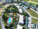 Aerial view of a condominium complex featuring a swimming pool, landscaping, and surrounding residential area with lush trees at 7503 Mourning Dove Cir # 101, Reunion, FL 34747