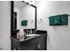 Elegant bathroom featuring a black granite countertop, gold fixtures, and dark wood cabinets at 7503 Mourning Dove Cir # 101, Reunion, FL 34747