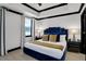 Inviting bedroom with stylish blue bed, modern decor, and natural light creating a calming atmosphere at 7503 Mourning Dove Cir # 101, Reunion, FL 34747