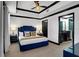 Serene bedroom with luxurious blue bed, modern lighting, and attached bathroom, offering a peaceful retreat at 7503 Mourning Dove Cir # 101, Reunion, FL 34747