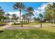 View of manicured walking paths, lush landscaping, and white gazebos with a fountain in a beautiful community setting at 7503 Mourning Dove Cir # 101, Reunion, FL 34747