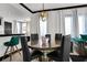 Elegant dining room featuring a round table, black chairs, and a stylish chandelier at 7503 Mourning Dove Cir # 101, Reunion, FL 34747