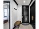 Elegant entryway with a black door, stylish bench, and modern accents at 7503 Mourning Dove Cir # 101, Reunion, FL 34747
