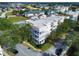 Exterior aerial view of a condominium building featuring multiple balconies, lush landscaping, and nearby neighborhood at 7503 Mourning Dove Cir # 101, Reunion, FL 34747