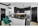 Modern kitchen with stainless appliances, granite countertop, and cozy breakfast bar with green chairs at 7503 Mourning Dove Cir # 101, Reunion, FL 34747