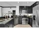 Stylish kitchen featuring stainless steel appliances and granite countertops with ample cabinet space at 7503 Mourning Dove Cir # 101, Reunion, FL 34747