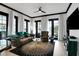 Bright living room featuring a brown leather sofa with green accents, statement rug, and multiple windows for natural light at 7503 Mourning Dove Cir # 101, Reunion, FL 34747