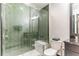 Modern shower with stylish green tiling and glass enclosure, providing a luxurious and contemporary bathing experience at 7503 Mourning Dove Cir # 101, Reunion, FL 34747