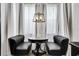 Cozy seating area with black chairs, marble table and natural light at 7503 Mourning Dove Cir # 101, Reunion, FL 34747