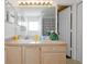 This bright bathroom has a large vanity, mirror with light, and shower/tub with blue curtain at 7807 Turkey Oak Ln, Kissimmee, FL 34747