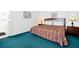 A clean bedroom features a large bed with unique bedding, and a lamp on each nightstand at 7807 Turkey Oak Ln, Kissimmee, FL 34747