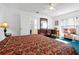 The bedroom has a ceiling fan, a dresser with mirror, and a TV on a desk with a chair at 7807 Turkey Oak Ln, Kissimmee, FL 34747
