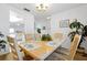 Bright dining room features a wooden table and seating for six, with a view to the kitchen at 7807 Turkey Oak Ln, Kissimmee, FL 34747