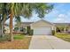 Charming single-story home featuring a two-car garage and a well-maintained front yard with mature landscaping at 7807 Turkey Oak Ln, Kissimmee, FL 34747