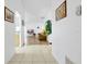 Hallway leads to a bright, inviting living room with wood floors and access to the kitchen at 7807 Turkey Oak Ln, Kissimmee, FL 34747