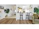 Bright kitchen featuring a breakfast bar, ample cabinet space, white appliances and tiled flooring at 7807 Turkey Oak Ln, Kissimmee, FL 34747