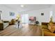 Bright living room featuring wood floors, neutral walls, comfortable seating and sliding glass door access to the lanai at 7807 Turkey Oak Ln, Kissimmee, FL 34747