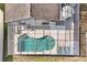 Aerial view of pool and screened in lanai with furniture, creating an outdoor oasis for relaxation and entertainment at 7807 Turkey Oak Ln, Kissimmee, FL 34747