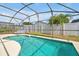 Pool features a screened enclosure and ample patio space with lounge chairs at 7807 Turkey Oak Ln, Kissimmee, FL 34747