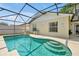 The screened pool area offers an in-ground pool and steps for easy access at 7807 Turkey Oak Ln, Kissimmee, FL 34747
