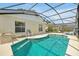 A screened pool area with ample seating, a built in grill and view of the backyard at 7807 Turkey Oak Ln, Kissimmee, FL 34747