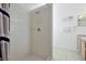 Shower with white tile surround and glass shelves, next to a bathroom vanity and mirror at 7807 Turkey Oak Ln, Kissimmee, FL 34747