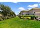 Spacious yard showcasing the property's lush lawn, garden, and secure fencing at 8262 Bayview Crossing Dr, Winter Garden, FL 34787