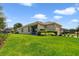 Expansive backyard featuring lush green grass, a well-maintained fence, and a covered patio at 8262 Bayview Crossing Dr, Winter Garden, FL 34787