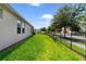 Well-maintained side yard featuring a lush lawn, privacy fence, and mature landscaping at 8262 Bayview Crossing Dr, Winter Garden, FL 34787
