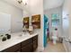This bathroom features a dark wood vanity, a full size mirror, and a shower and bathtub combination at 8262 Bayview Crossing Dr, Winter Garden, FL 34787