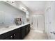The bathroom features a double vanity, frameless shower, and a large mirror, creating a luxurious and functional space at 8262 Bayview Crossing Dr, Winter Garden, FL 34787