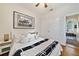 Modern and cozy bedroom with wood floors, a ceiling fan, walk in closet, and lots of natural light at 8262 Bayview Crossing Dr, Winter Garden, FL 34787