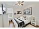 Modern bedroom featuring lots of natural light, wood floors, decor on the walls, and a white color scheme at 8262 Bayview Crossing Dr, Winter Garden, FL 34787