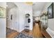 Inviting entryway with wood floors, coat rack, and neutral decor leading to the dining and kitchen areas at 8262 Bayview Crossing Dr, Winter Garden, FL 34787