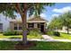 Charming single-story home with stone accents, manicured landscaping and a brick walkway leading to the front door at 8262 Bayview Crossing Dr, Winter Garden, FL 34787