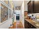 Hallway featuring a laundry room, wood floors, decorative decor, and dark wood cabinets at 8262 Bayview Crossing Dr, Winter Garden, FL 34787
