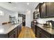 Stylish kitchen featuring dark cabinets, granite counters, a large island and stainless steel appliances at 8262 Bayview Crossing Dr, Winter Garden, FL 34787