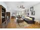 Cozy living room featuring hardwood floors, a leather couch, and decorative wall art at 8262 Bayview Crossing Dr, Winter Garden, FL 34787