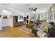 Open living area features wood floors, a sectional sofa, and neutral decor at 8262 Bayview Crossing Dr, Winter Garden, FL 34787