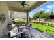 Charming covered patio featuring a ceiling fan, outdoor furniture, and elegant string lights at 8262 Bayview Crossing Dr, Winter Garden, FL 34787