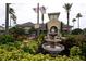 Community clubhouse with a fountain, lush landscaping, and American flags at 8271 Maritime Flag St # 109, Windermere, FL 34786