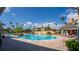 Resort-style pool area features lounge chairs, mature palms, and meticulously maintained landscaping for relaxed outdoor living at 8271 Maritime Flag St # 109, Windermere, FL 34786